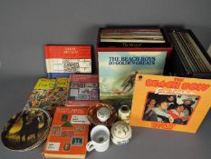 A mixed lot comprising vinyl records to include The Beach Boys, The Stylistics, Paul Simon,