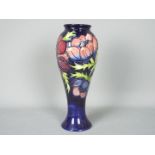 Moorcroft - A Moorcroft Pottery vase of inverted baluster form decorated with anemone against a