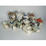 A collection of teapots, predominantly Sadlers.