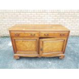 A sideboard with twin cupboards and drawers, approximately 79 cm x 122 cm x 51 cm.