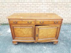 A sideboard with twin cupboards and drawers, approximately 79 cm x 122 cm x 51 cm.