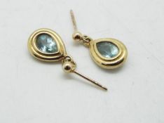 A pair of 9ct gold stone set earrings, set with light blue stone, approximately 2 grams all in.