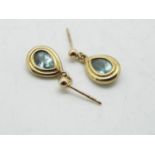 A pair of 9ct gold stone set earrings, set with light blue stone, approximately 2 grams all in.