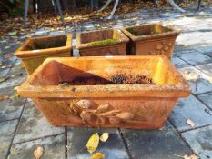 Four terracotta planters comprising three cuboid ones measuring 13 cm x 23 cm x 23 cm,