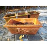 Four terracotta planters comprising three cuboid ones measuring 13 cm x 23 cm x 23 cm,