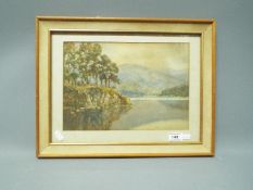 A late 19th or early 20th century watercolour landscape depicting a lakeside scene,