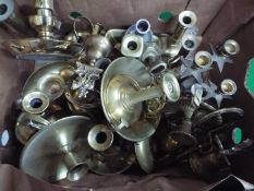 A quantity of brass and other metal ware, predominantly candlesticks / chambersticks.