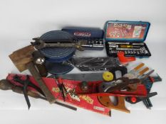 A collection of vintage hand tools, a potter's wheel and similar.