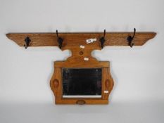 A wall mountable coat rack with mirror, approximately 42 cm x 84 cm.