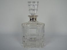 A Mappin & Webb hallmarked silver collared, cut glass decanter, London assay.