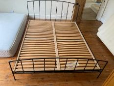 A metal framed double bed.