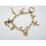 A 9ct gold charm bracelet with safety chain, with a quantity of 9ct charms, 20 cm length,