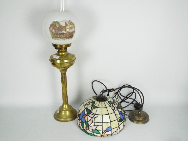 A brass column oil lamp with white shade,