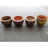 Four garden planters of cylindrical form, largest approximately 30 cm x 40 cm.