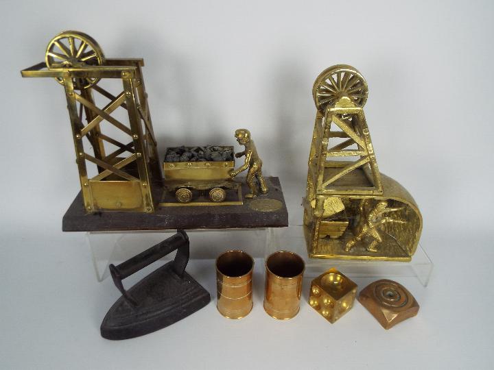 Metalware to include a wood and brass model of a miner with cart at a pit head,