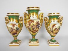 A garniture of three Vienna style vases decorated with panels of landscape scenes highlighted with