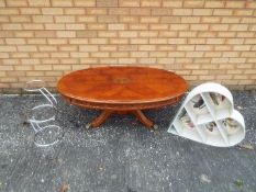 A oval topped coffee table with inlaid decoration, approximately 43 cm x 120 cm x 70 cm,