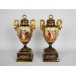 A pair of Vienna style urns and covers raised on square bases,