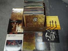 A collection of 12" vinyl records to include Alice Cooper, The Spencer Davis Group, Cher,