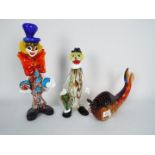 Three Murano and similar glass ornaments, two clowns and a fish, largest approximately 31 cm (h).
