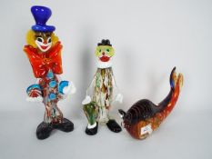 Three Murano and similar glass ornaments, two clowns and a fish, largest approximately 31 cm (h).