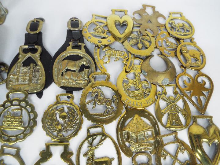 Two brass money banks comprising a standing bear and Humpty Dumpty and a quantity of horse brasses. - Image 3 of 5