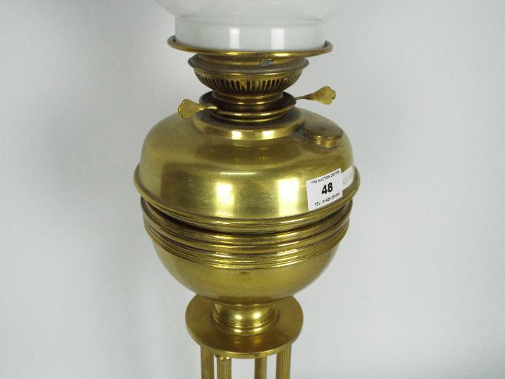 A brass oil lamp on circular base with four column supports, the shade decorated with game birds, - Image 3 of 11