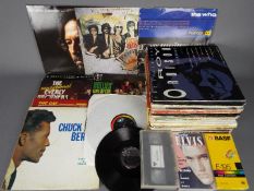 A quantity of 12" vinyl records to include The Traveling Wilburys, Chuck Berry, Jimmy Smith,