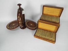 A folding cake stand with inlaid decoration and two carved wooden boxes containing English - German