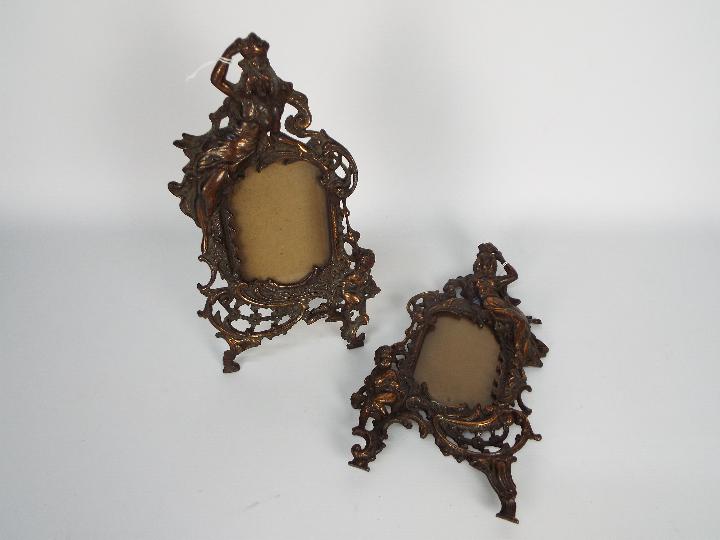 A pair of cast iron, rococo style photograph / picture frames, each approximately 35 cm (h).