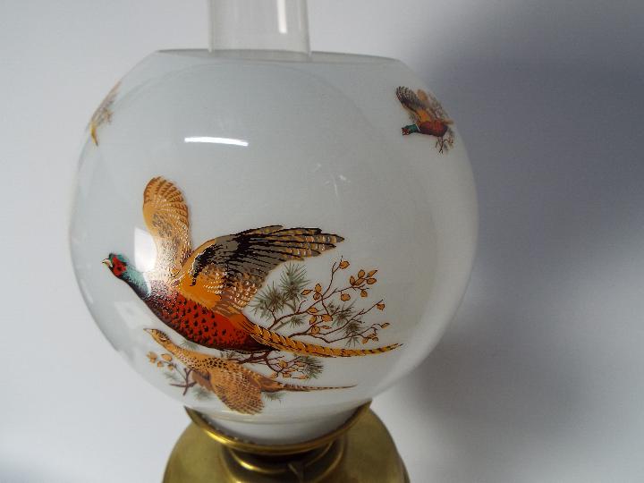 A brass oil lamp on circular base with four column supports, the shade decorated with game birds, - Image 11 of 11