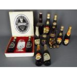 A collection of vintage beer bottles with contents to include Guinness, Harp, Skol,