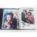 A binder containing a collection of film and TV promotional photos, some with facsimile signatures.