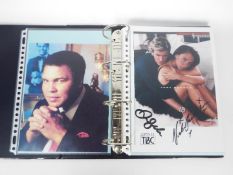 A binder containing a collection of film and TV promotional photos, some with facsimile signatures.