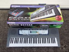 A boxed Yamaha EZ-200 electronic keyboard.
