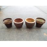 Four garden planters of cylindrical form, largest approximately 34 cm x 34 cm.