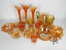 A collection of carnival and similar glassware to include vases, bowls, jugs and similar.