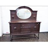 A mirror back, oak sideboard with carved detailing, approximately 173 cm x 153 cm x 55 cm.