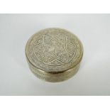 An Egyptian silver circular box and cover with chased decoration,