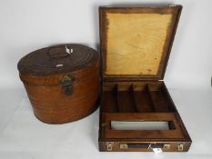 A Victorian, painted tin hat box, approximately 29 cm (h) and a wooden case with fitted interior.