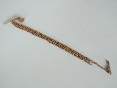 A 9ct gold watch chain with T bar and fob, 43 cm (l) and approximately 40 grams all in.