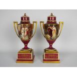 A pair of Vienna style porcelain urns and covers,