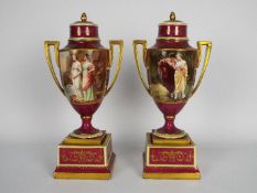A pair of Vienna style porcelain urns and covers,