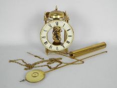 A Hermle, skeleton type wall clock with one weight and pendulum,