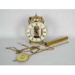 A Hermle, skeleton type wall clock with one weight and pendulum,