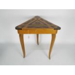 An inlaid musical sewing table with Lador Swiss movement which plays the theme from Love Story when