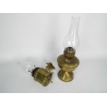 Two brass oil lamps, one with wall mount, largest approximately 40 cm (h) including chimney.