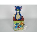 A vintage tin plate Tom and Jerry Jack In The Box by Rosebud Mattel.