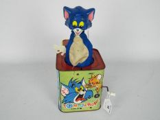 A vintage tin plate Tom and Jerry Jack In The Box by Rosebud Mattel.