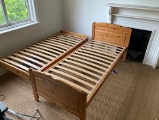 A pine framed single bed with slide out